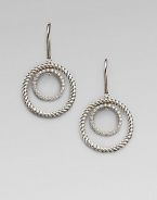 A circle of cabled sterling silver surrounds a sparkling pavé diamond-encrusted inner loop in these dangling earrings with a mobile-like design. Diamonds, 0.31 tcw Sterling silver Drop, about ¾ Ear wire Imported