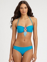 Bohemian beads add exotic charm to this stretch swim design with a convenient, removable halter strap. Removable halter strap ties at neckBandeau topBack clasp closureStretch bottom features beaded sidesFully lined80% nylon/20% spandexHand washImported