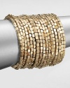 Satin finished, goldtone beading makes a dramatic statement in this coil wrap design.Brass Diameter, about 2½ Imported 
