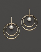 Beautiful textures in 14 Kt. yellow gold. A double hoop earring with fresh water pearl center.