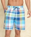 Look sharp in the sea or sand with these Tommy Hilfiger plaid swim trunks.