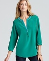 A lightweight Joie top in pure silk flaunts an alluring deep V neckline adorned with chic color blocked trim.