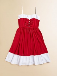 An eye-catching colorblock design with ruffles and a full skirt make this fancy frock the ultimate must-have.Sweetheart necklineAdjustable spaghetti strapsPullover styleRuffled ribbon bodice with button detailFull skirt92% polyester/8% spandexHand washMade in the USA of imported fabric An eye-catching colorblock design with ruffles and a full skirt make this fancy frock the ultimate must-have.Sweetheart necklineAdjustable spaghetti strapsPullover styleRuffled ribbon bodice with button detailFull skirt92% polyester/8% spandexHand washMade in the USA of imported fabric