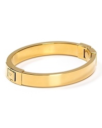 A subtle touch of shine, MICHAEL Michael Kors' gold bangle defines versatile. Wear the shapely hinged style to add a silvery polish to any outfit. A subtle touch of shine, MICHAEL Michael Kors' gold bangle defines versatile. Wear the shapely hinged style to add a silvery polish to any outfit.