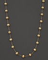 Textured bead stations lend bold style to this 18 karat gold necklace from Marco Bicego.