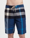 Classic swim short style in a colorful yarn-dyed check print.Drawstring waistSide slash pocketsCotton/nylonMachine washImported