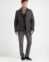 A double-breasted outerwear silhouette crafted in a superior wool blend, featuring leather pocket detailing for a uniquely tailored finish.Button-frontWaist slash pocketsFully linedAbout 27 from shoulder to hem80% wool/20% polyamideDry cleanImported