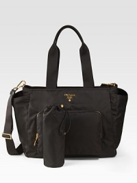 A functional nylon tote with changing pad and bottle cover, features exterior zip pockets and open pockets for easy access.Double top handles, 9½ drop Removable, adjustable shoulder strap, 18-22 drop Top zip closure Two outside zip pockets Two outside open pockets One inside zip pocket Two inside open pockets Signature jacquard lining 14W X 12H X 7D Made in Italy A functional nylon tote with changing pad and bottle cover, features exterior zip pockets and open pockets for easy access.Double top handles, 9½ drop Removable, adjustable shoulder strap, 18-22 drop Top zip closure Two outside zip pockets Two outside open pockets One inside zip pocket Two inside open pockets Signature jacquard lining 14W X 12H X 7D Made in Italy