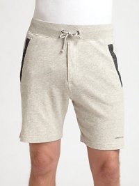 A sophisticated presence that doesn't sacrifice comfort, these cotton knit sweat shorts are sharpened by contrast detail at the pockets and signature logo detail.Drawstring waistSide slash, back welt pocketsInseam, about 6CottonMachine washImported