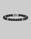 A strand of dramatic matte-finish black onyx beads, with a bold clasp and stations of hand-forged sterling silver.8mm matte onyx beads Sterling silver Length, about 9 Lobster clasp Made in USA