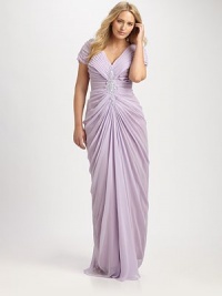 Wrap your curves in luxury. This gown features a stunning embellishment and flattering pleats throughout the bodice. V-necklineShort sleeves for moderate arm coverageEmbellished detail at centerPretty pleats throughout bodiceConcealed back zipperAbout 46 from natural waistFully linedPolyesterDry cleanImported Wrap your curves in luxury. This gown features a stunning embellishment and flattering pleats throughout the bodice. V-necklineShort sleeves for moderate arm coverageEmbellished detail at centerPretty pleats throughout bodiceConcealed back zipperAbout 46 from natural waistFully linedPolyesterDry cleanImported