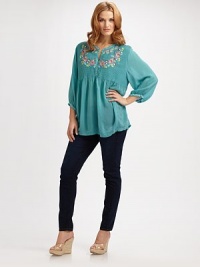 Pretty horizontal pintucking and exquisite embroidery distinguish the bodice of this graceful tunic of dreamy crinkle rayon.Narrow band neckline with embroidered detailButton placketColorful floral embroidery at bodice, back and one side of hemFull three-quarter sleeves with button band cuffs and zigzag embroideryAbout 31½ from shoulder to hemRayonImportedMachine wash Pretty horizontal pintucking and exquisite embroidery distinguish the bodice of this graceful tunic of dreamy crinkle rayon.Narrow band neckline with embroidered detailButton placketColorful floral embroidery at bodice, back and one side of hemFull three-quarter sleeves with button band cuffs and zigzag embroideryAbout 31½ from shoulder to hemRayonImportedMachine wash
