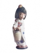 Wearing a traditional Japanese kimono and pretty hair comb, this little girl is ready for her biggest dance performance yet. Handcrafted in Lladro porcelain.