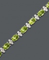 Inspired by spring. This light and airy tennis bracelet features gleaming oval-cut peridot (14 ct. t.w.) alongside diamond-accented links. Crafted in sterling silver. Approximate length: 7 inches.