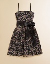 A brilliant flower print and satin sash lend an elegant touch to a pretty party frock.Square necklineAdjustable spaghetti strapsConcealed back zipperWaistband with sashFull skirtPolyester/spandexDry cleanMade in USA of imported fabric