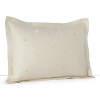 Delicately embroidered ginkgo leaves dance across soft green sateen in this elegant decorative pillow from Barbara Barry's Fern Canopy collection.
