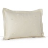 Delicately embroidered ginkgo leaves dance across soft green sateen in this elegant decorative pillow from Barbara Barry's Fern Canopy collection.