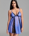 Strut to bed in this sheer, lace-paneled babydoll and matching thong from Betsey Johnson.