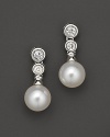 Two bezel-set diamond studs with cultured Akoya pearls; in a linear design.