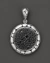 From the Kali collection, a medium round enhancer with featuring black sapphires and framed in sterling silver,designed by John Hardy.