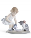 An adorable little girl dotes on her kitten, both the picture of innocence in exquisite, softly shaded Lladro porcelain.