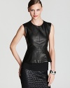 Turn up the glamour quotient with this sleek leather DIANE von FURSTENBERG top--a pop of a peplum is one of our favorite fall trends that adds ladylike panache to this dark beauty.