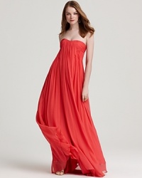 Rendered in rich silk, this sweeping Halston Heritage strapless gown boasts fluid lines for exquisite movement. Rendered in rich silk, this sweeping Halston Heritage strapless gown boasts fluid lines for exquisite movement.