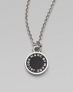 A delicate enamel disc pendant with signature logo.Enamel Palladium and real rhodium plated or 10K goldplated brass Length, about 16 Pendant diameter, about ½ Imported 