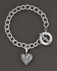 An edgy charm bracelet centered on a chunky sterling silver bracelet with etched heart pendant. Designed by Lagos. An edgy charm bracelet centered on a chunky sterling silver bracelet with etched heart pendant. Designed by Lagos.