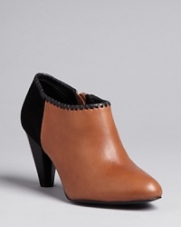 Black and tan: Jack Rogers brings contrast into the on-trend bootie silhouette with a touch of Western style-whipstitched trim. Black and tan: Jack Rogers brings contrast into the on-trend bootie silhouette with a touch of Western style-whipstitched trim.