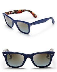 Your inner rock star will appreciate the hidden guitar print on the interior of these Ray-Ban Wayfarer sunglasses; true blue frames top off all your denim looks. Your inner rock star will appreciate the hidden guitar print on the interior of these Ray-Ban Wayfarer sunglasses; true blue frames top off all your denim looks.