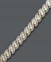 Twist and shine. This stunning tennis bracelet combines a spiraling design with sparkling, round-cut diamonds (3 ct. t.w.). Set in 10k gold. Approximate length: 7-1/2 inches.