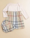 A t-shirt soft top is joined by a woven checked skirt in this adorable design that dresses up your little one in cotton comfort.Round ribbed necklineEnvelope shoulders for pullover easeLong sleevesGathered Empire waistFull woven skirtMatching bloomers with elasticized waist and leg openingsCottonMachine washImported