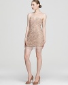 A sheer mesh bodice lends mysterious allure to BCBGMAXAZRIA's seductive cocktail dress, crafted in intricate floral lace.