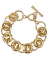 Slip on designer style. This Kenneth Cole New York bracelet features golden links with a trendy toggle clasp. Approximate length: 7-1/2 inches. Approximate width: 5/8 inch.