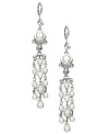 Gown, bouquet, accessories! These flowing chandelier-shaped bridal earrings by Givenchy are the perfect something new for your big day. Crafted in silver-plated mixed metal, earrings feature glass pearls and white glass accents. Approximate drop: 3-7/8 inches.
