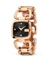 A Gucci bracelet watch with rose gold-tone links makes a luxe presentation with a sleek black face.