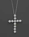 Faceted diamonds set in a gleaming 18K white gold cross.
