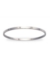 Get noticed for your charming subtlety with this simple matte bangle set with shimmering, clear crystals. Crafted in rhodium-plated mixed metal. Approximate diameter: 3-1/4 inches.