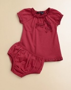 A frilly, girlie set with lace trim, bows and matching bloomers is perfect for any occasion.Crewneck with lace trimShort cap sleeves with lace trimPullover styleGathered bodiceA-line silhouetteMatching bloomers have elastic waistband and leg openingsCottonMachine washImported