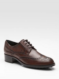 Oxford-inspired, leather style has a lace-up front and intricate cut-out details. Leather upper Leather lining Rubber sole Padded insole Made in Italy Oxford-inspired, leather style has a lace-up front and intricate cut-out details. Leather upper Leather lining Rubber sole Padded insole Made in Italy