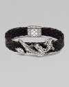 An intricately detailed sterling silver dragon wraps itself around a band of braided leather.SilverBraided leatherPush-lock claspAbout 8½ longAbout ¾ wideImported