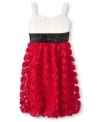 A unique textured skirt and a classic empire waist give this Ruby Rox dress its beautiful style.