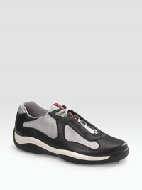 Lace-up sneaker with leather and mesh upper on a rubber sole. Padded insole Molded rubber bottom Imported Lace-up sneaker with leather and mesh upper on a rubber sole. Padded insole Molded rubber bottom Imported