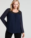 Gain instant style credo in this DKNYC Plus blouse touting chic color blocking and sheer detailing for modern femininity.