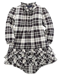 A traditional, festive plaid is constructed with a pintucked front and a flurry of ruffle trim along the neck and hem. A traditional, festive plaid is constructed with a pintucked front and a flurry of ruffle trim along the neck and hem.