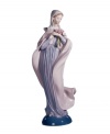 Cloaked in soft pastels and clutching a pink bouquet, the Lady with Flowers figurine from Lladro has an air of quiet elegance in handcrafted porcelain.