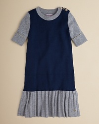 A pretty prim school-girl look with a drop waist, pleated skirt and striking goldtone accents. A pretty prim school-girl look with a drop waist, pleated skirt and striking goldtone accents.