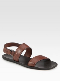 Signature gancini stamped leather shapes this casual slip-on with back buckle strap.Calfskin upperLeather liningPadded insoleRubber soleMade in Italy Signature gancini stamped leather shapes this casual slip-on with back buckle strap.Calfskin upperLeather liningPadded insoleRubber soleMade in Italy