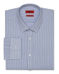 A slim fit HUGO dress shirt touts a plaid pattern and traditional barrel cuffs for streamlined office polish.